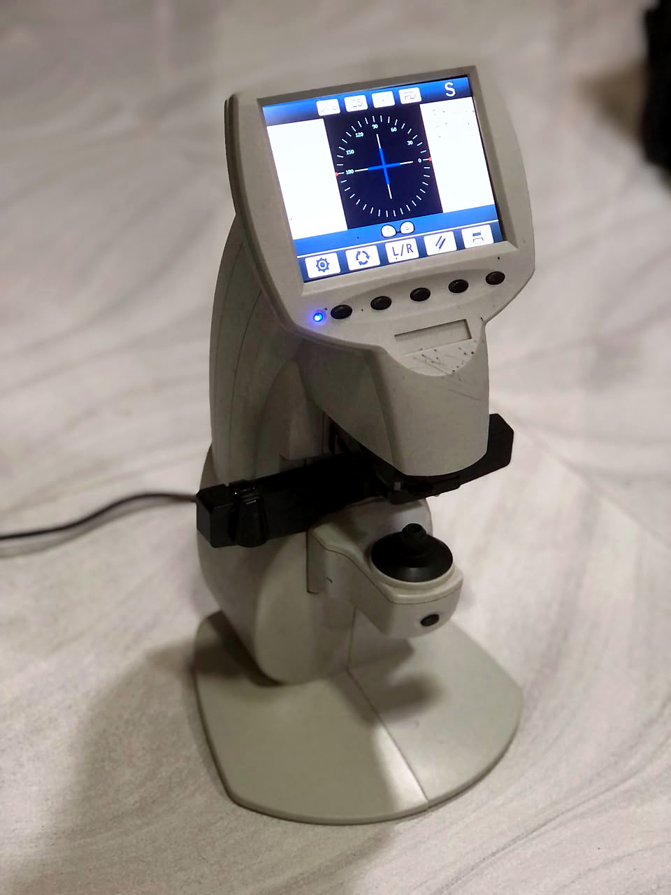 Digital lensmeter with an on-screen alignment display in our laboratory