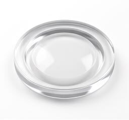 Lenticular lens with a central optical zone and outer carrier